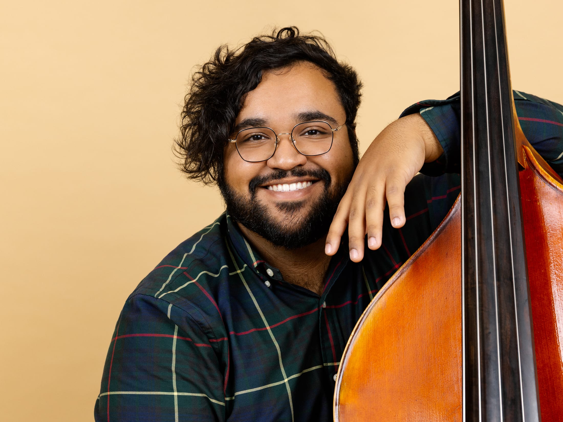 Michael Santos smiling, resting on his upright bass